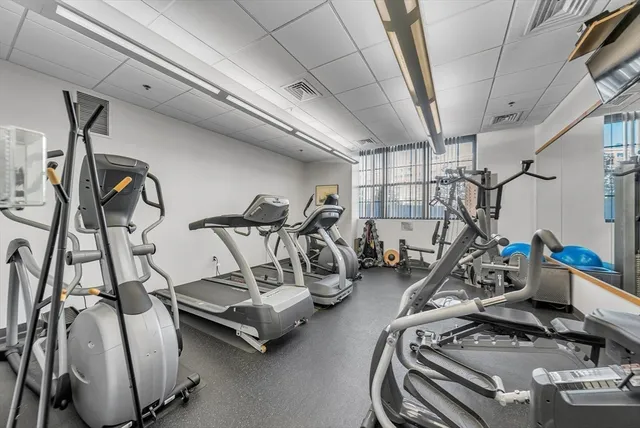a room with gym equipment and windows