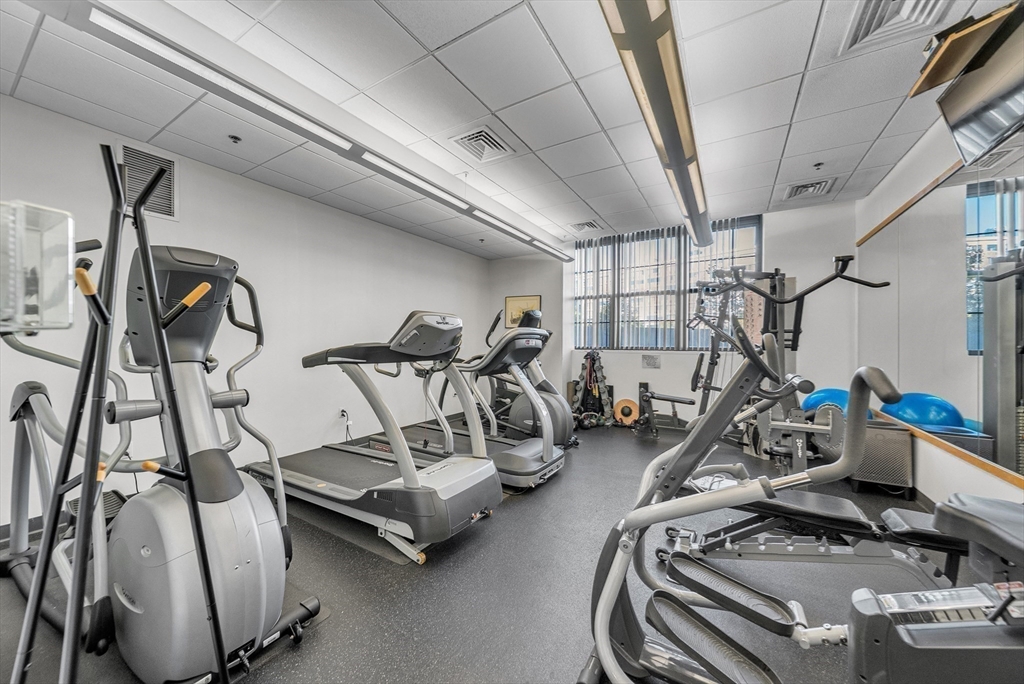 17 Otis Street, Unit 602 Cambridge, MA 02141 - Photo 9 of 40 a room with gym equipment and windows