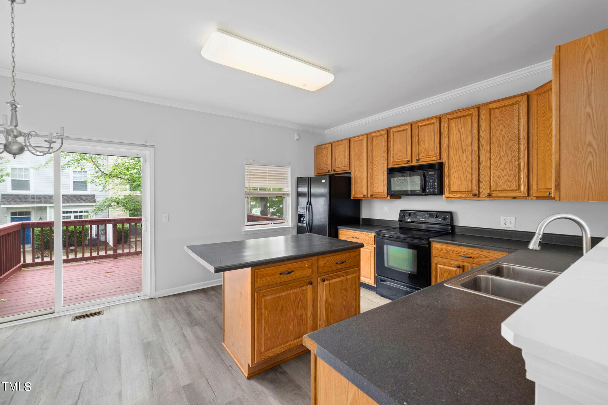 1237 Stone Manor Drive Raleigh, NC 27610 - Photo 13 of 29 a kitchen with stainless steel appliances granite countertop a stove top oven a sink dishwasher a dining table and chairs with wooden floor