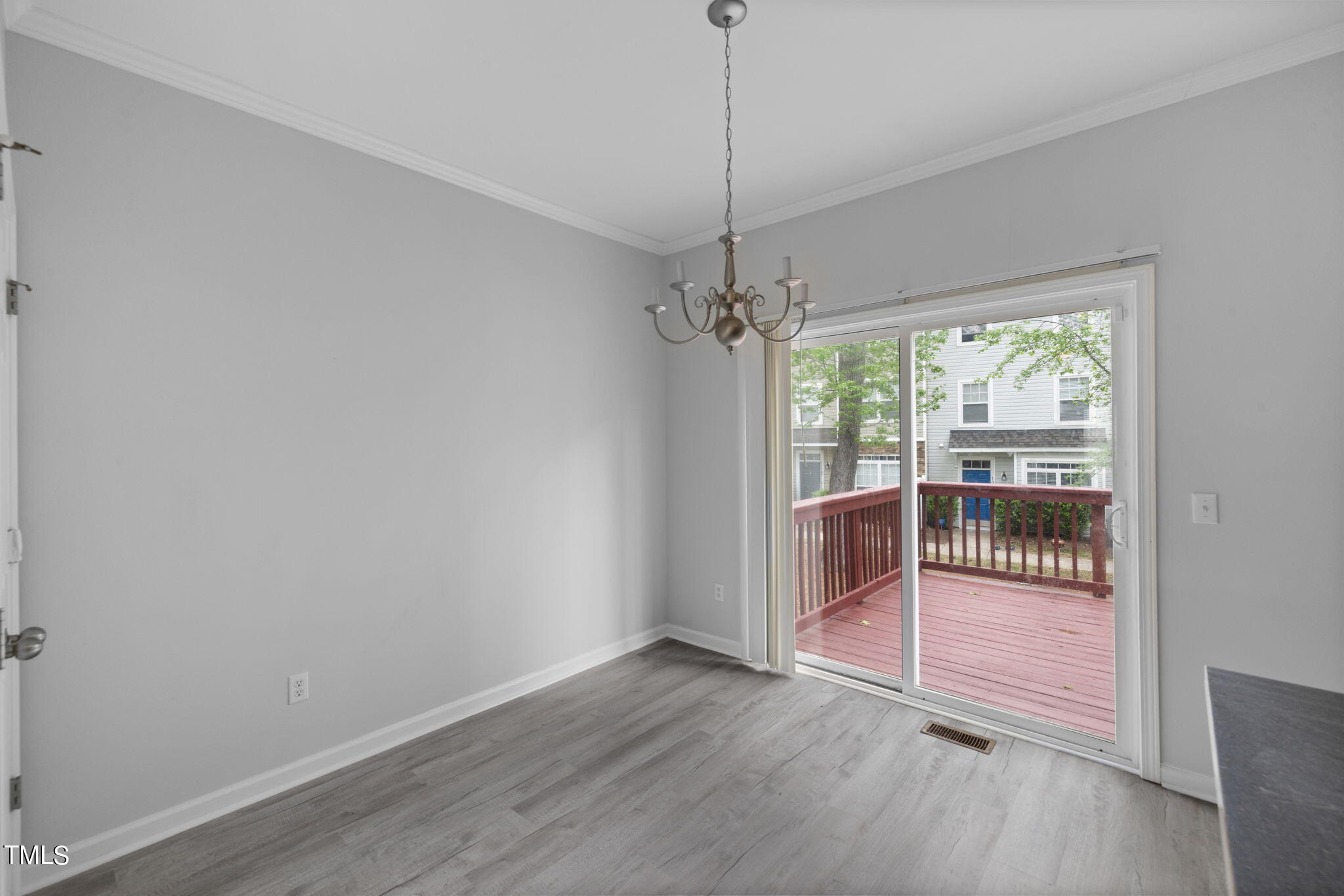 1237 Stone Manor Drive Raleigh, NC 27610 - Photo 15 of 29 a view of an empty room with wooden floor and a window