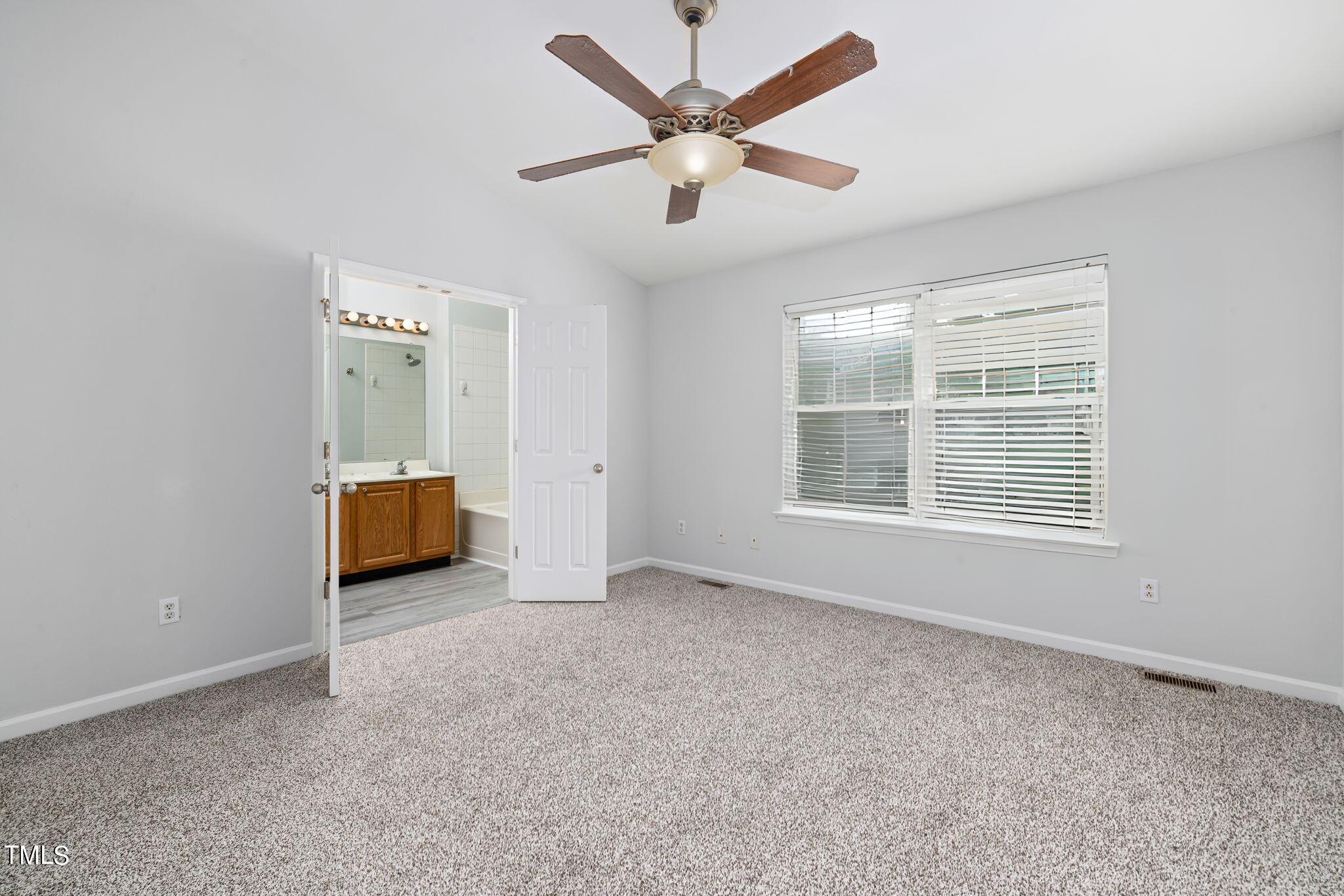 1237 Stone Manor Drive Raleigh, NC 27610 - Photo 17 of 29 a view of a livingroom with a ceiling fan and window