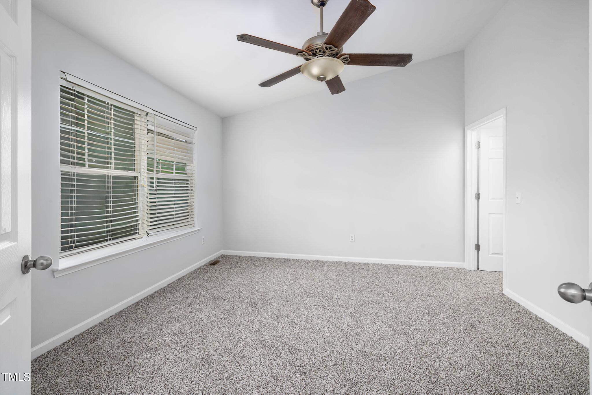 1237 Stone Manor Drive Raleigh, NC 27610 - Photo 18 of 29 a view of an empty room with a window