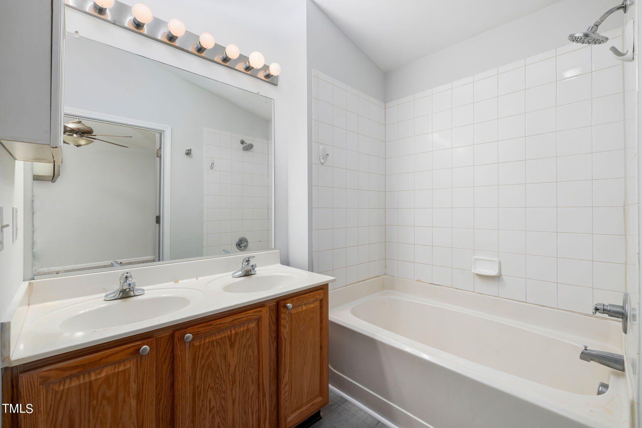 1237 Stone Manor Drive Raleigh, NC 27610 - Photo 20 of 29 a bathroom with a tub a sink and mirror
