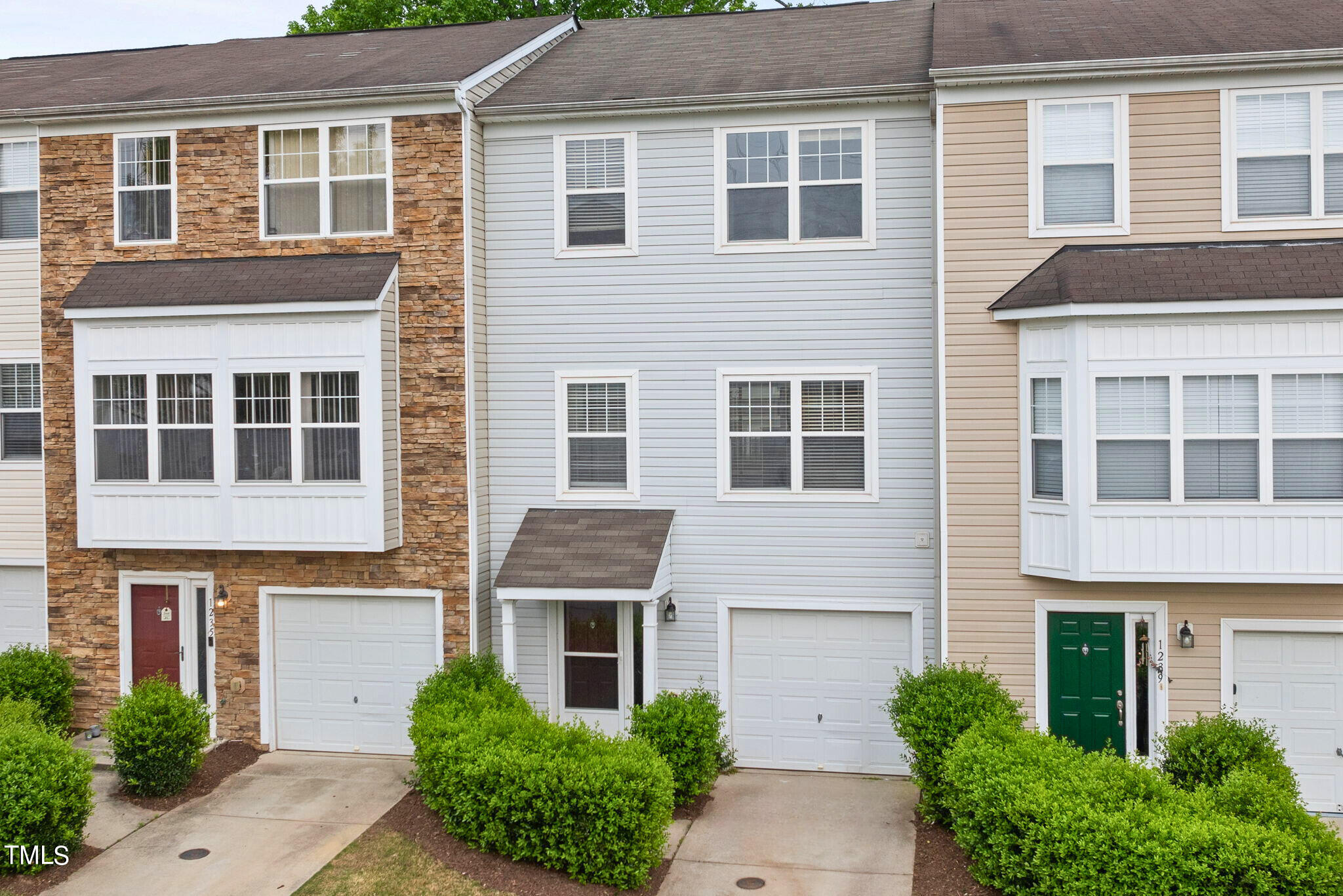 1237 Stone Manor Drive Raleigh, NC 27610 - Photo 2 of 29 a front view of a house with a yard and potted plants