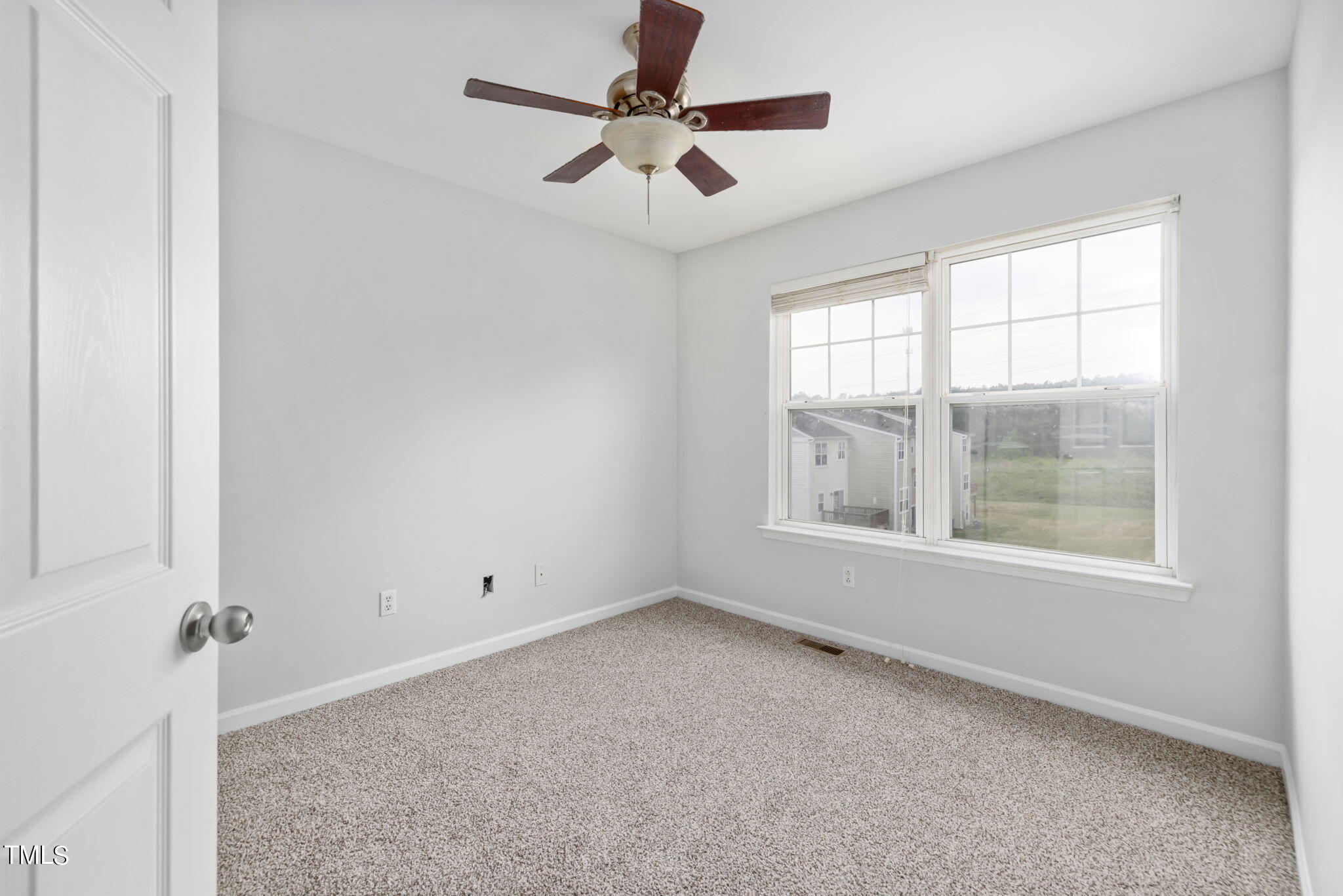 1237 Stone Manor Drive Raleigh, NC 27610 - Photo 21 of 29 an empty room with chandelier fan and windows