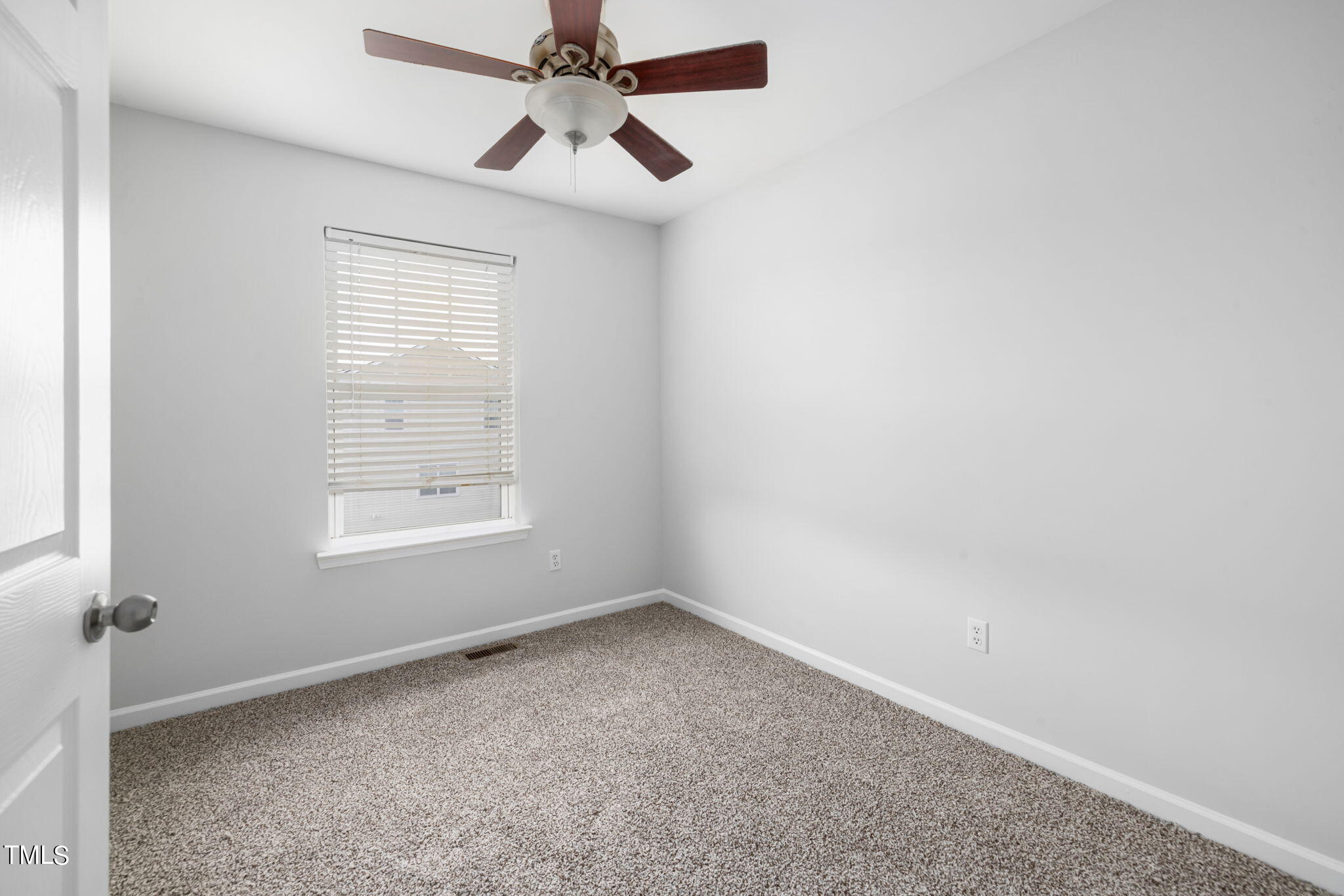 1237 Stone Manor Drive Raleigh, NC 27610 - Photo 23 of 29 an empty room with a window and a fan