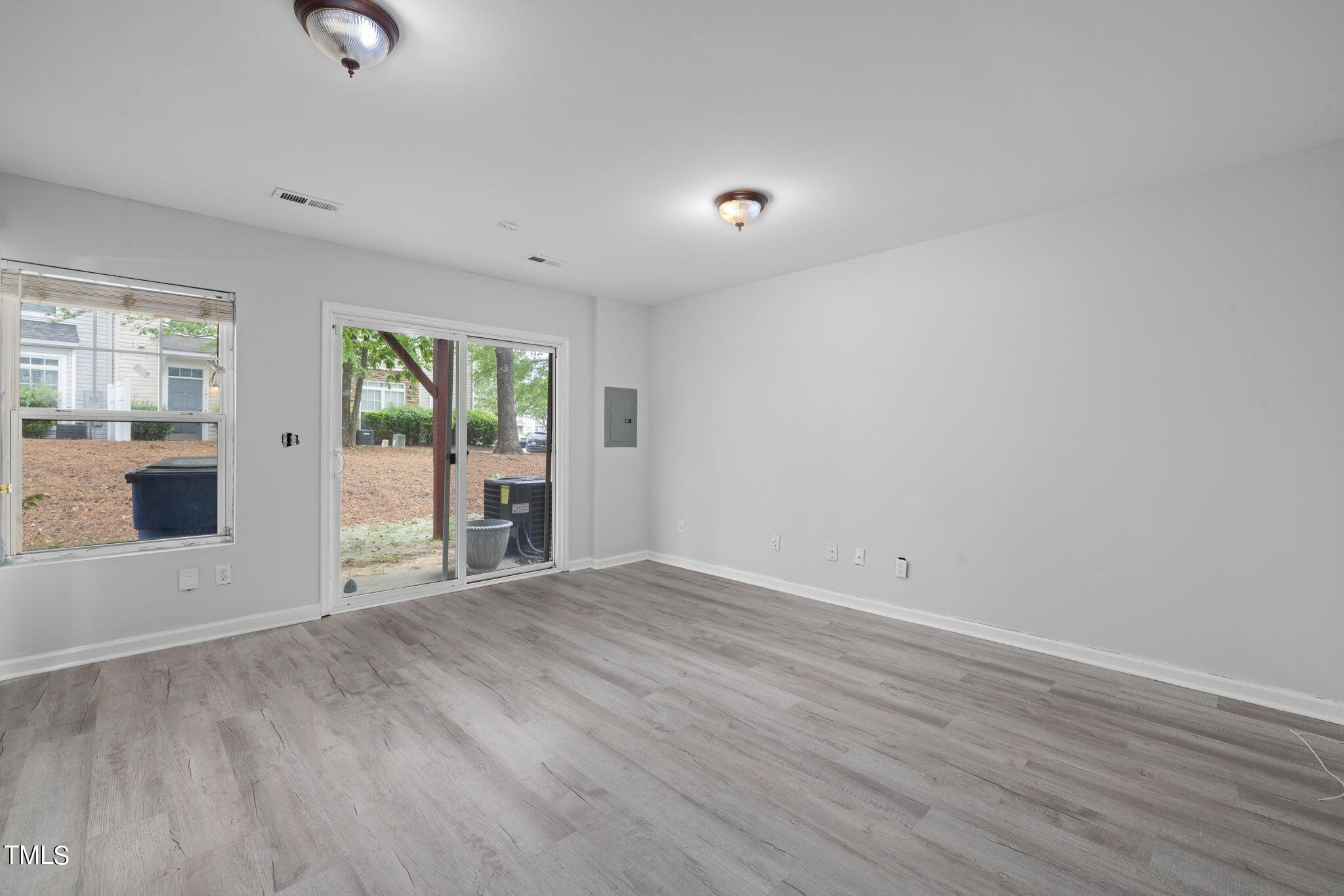 1237 Stone Manor Drive Raleigh, NC 27610 - Photo 25 of 29 wooden floor in an empty room with a window