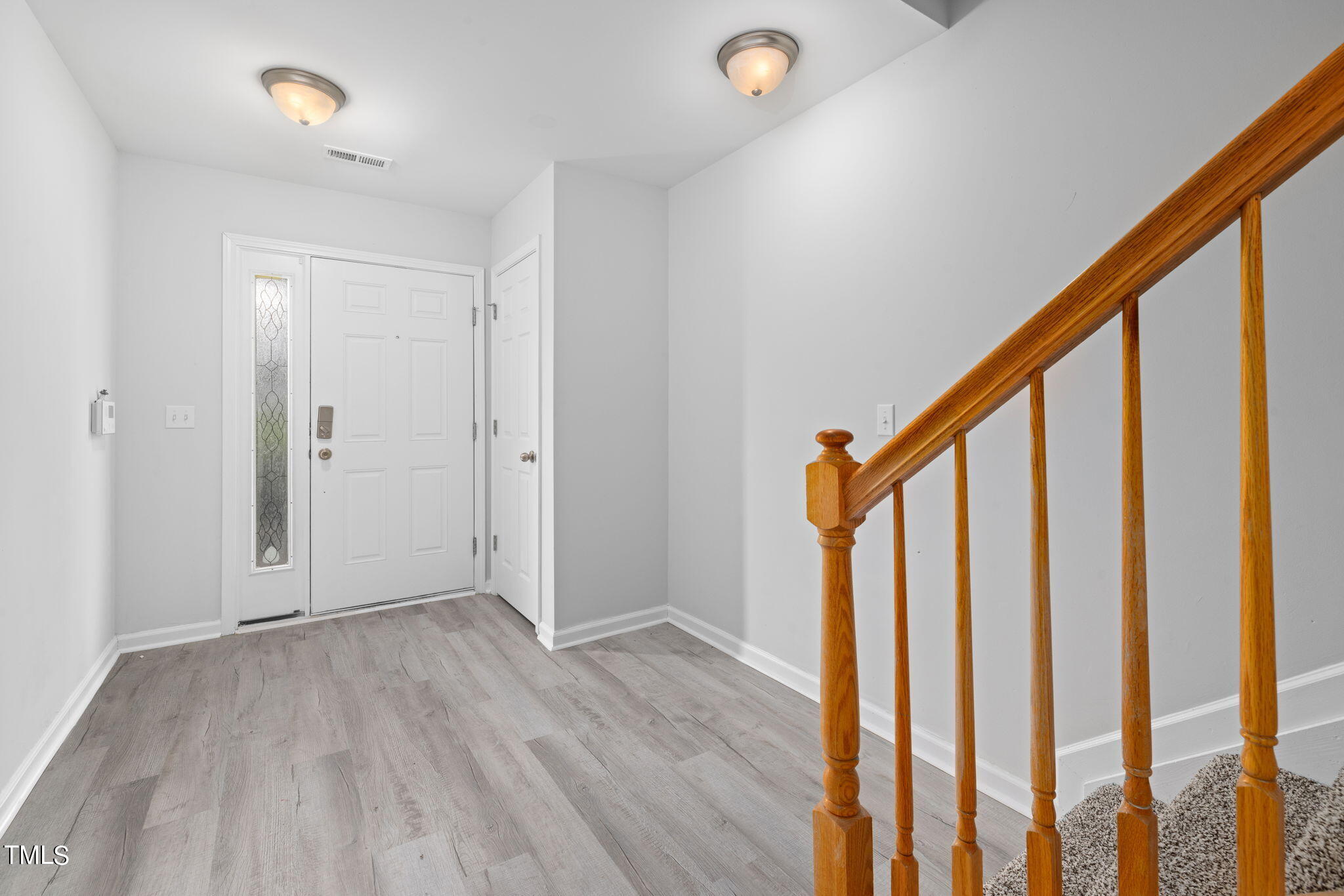 1237 Stone Manor Drive Raleigh, NC 27610 - Photo 4 of 29 a view of an entryway with wooden floor