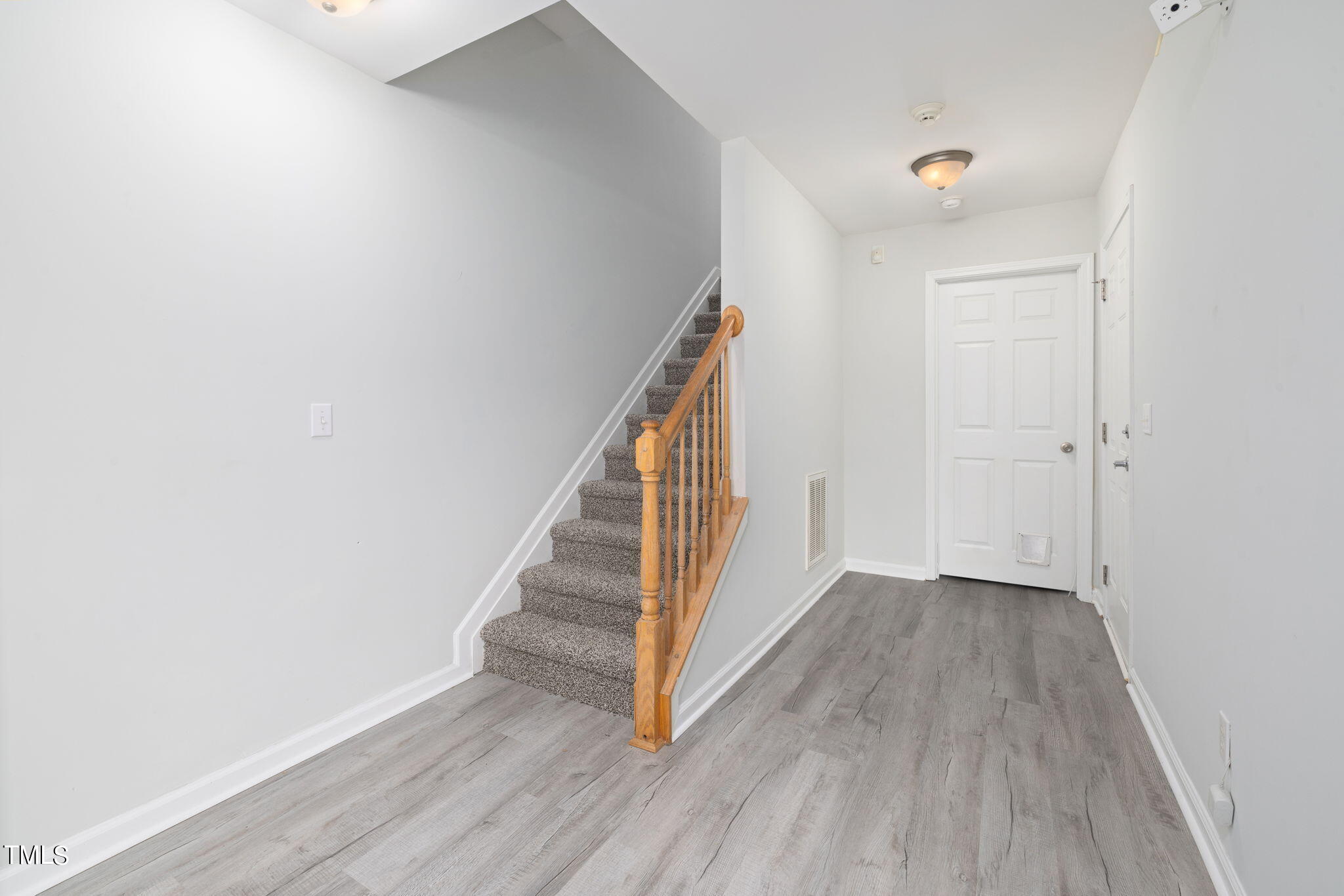 1237 Stone Manor Drive Raleigh, NC 27610 - Photo 5 of 29 a view of a hallway with wooden floor