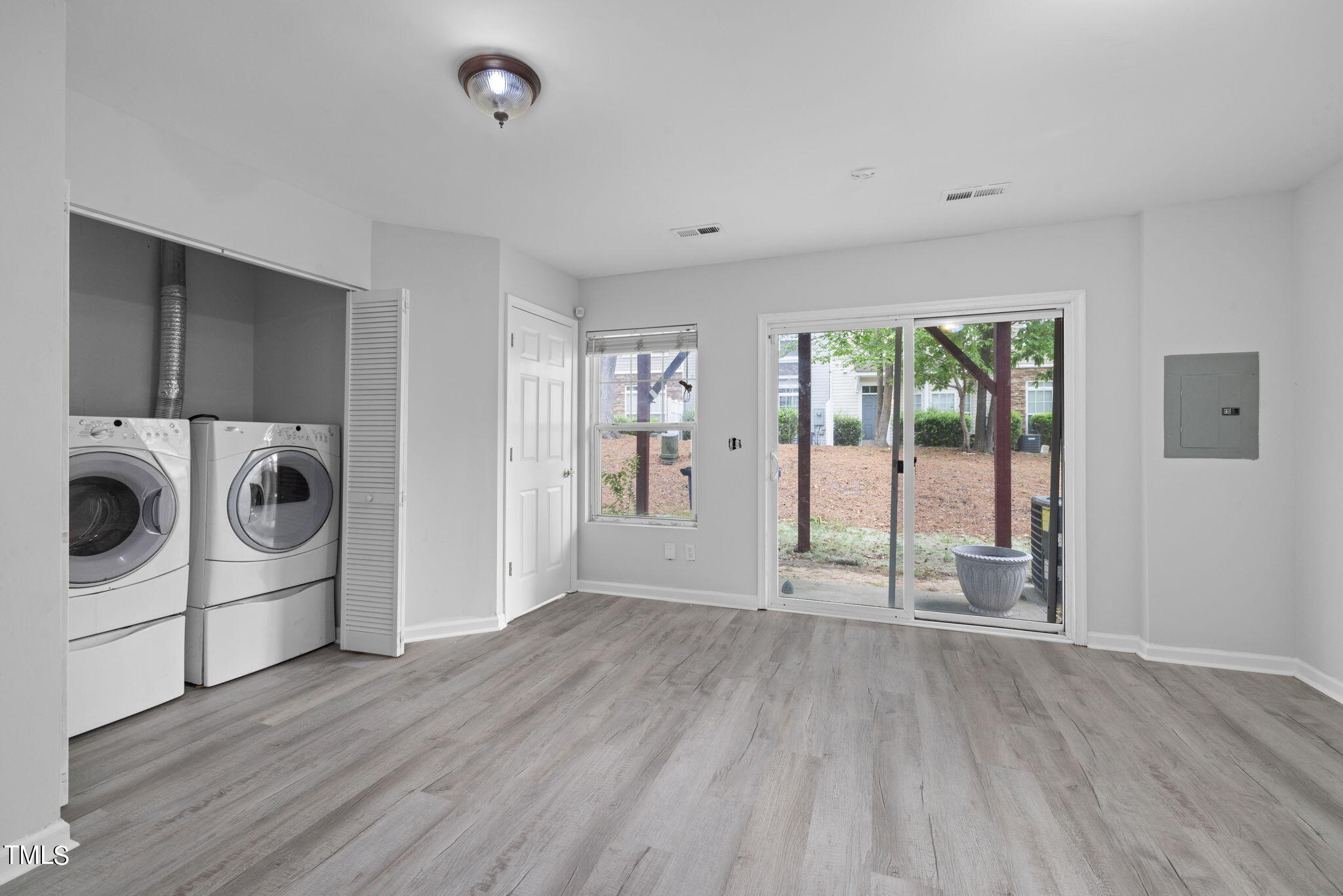 1237 Stone Manor Drive Raleigh, NC 27610 - Photo 6 of 29 a view of a big room with wooden floor and windows