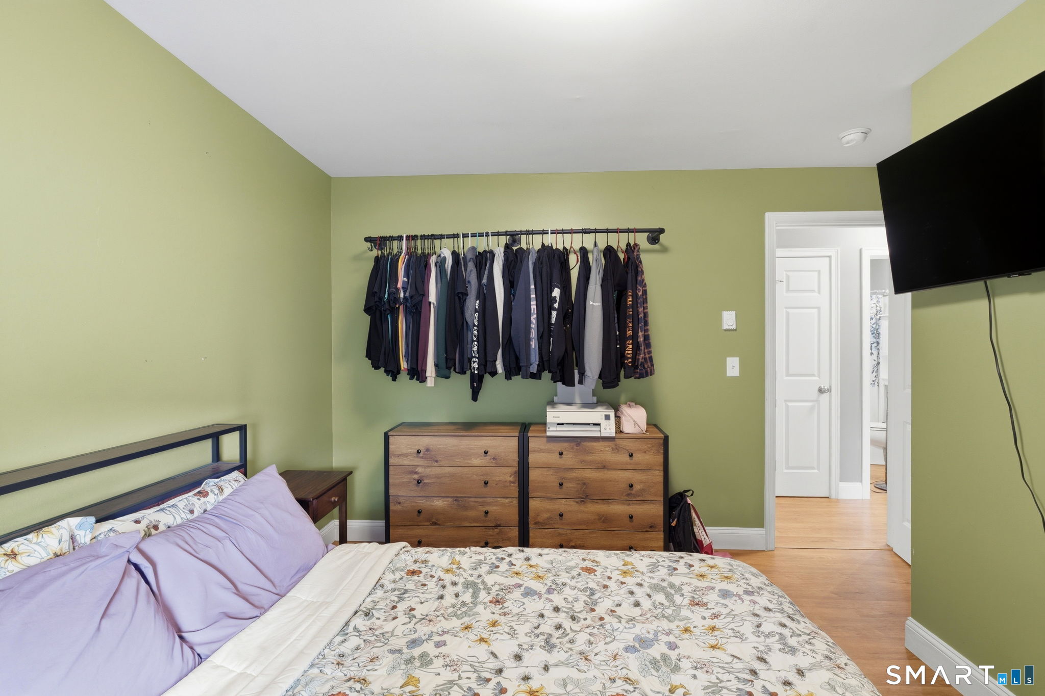 71 Smith Street Putnam, CT 06260 - Photo 5 of 25 a bedroom with a bed a mirror and dresser