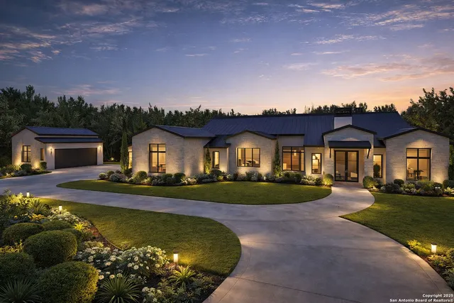 a front view of a house with a garden and lake view
