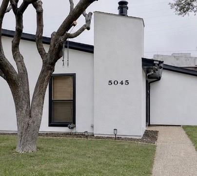5045 Thunder Road Dallas, TX 75244 - Photo 1 of 28 a front view of a house with garden