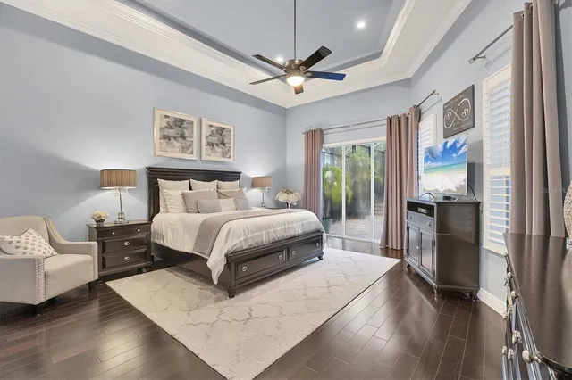 a bedroom with a large bed and a tv