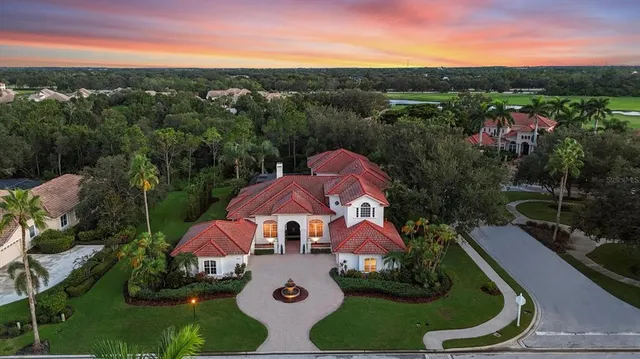 an aerial view of a house with garden space lake view and mountain view in back