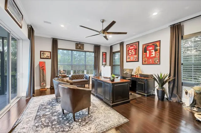 a living room with furniture and floor to ceiling windows