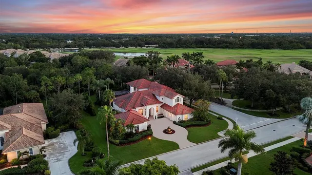 an aerial view of residential house with outdoor space and swimming pool