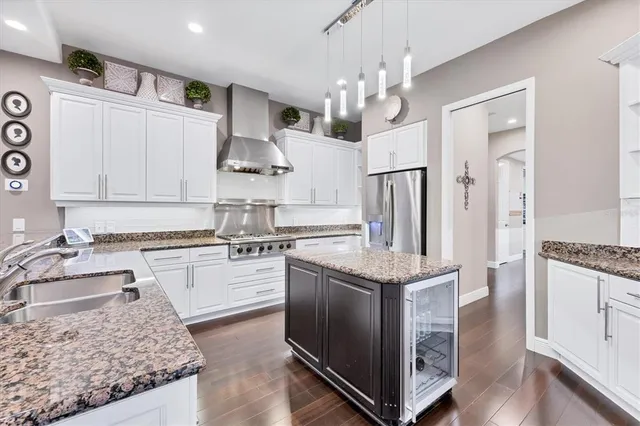 a kitchen with stainless steel appliances granite countertop a stove and a sink