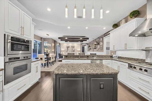 a view of a a dining room with furniture window and wooden floor