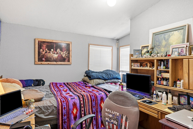 4296 Maple Lane Cedar City, UT 84721 - Photo 22 of 44 Interior room featuring light gray walls and a vaulted ceiling