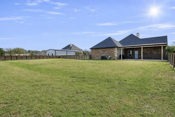 a view of a house with a garden and a yard