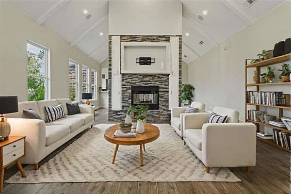 a living room with furniture a rug and a fireplace
