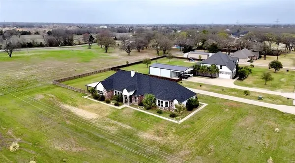 an aerial view of residential houses with outdoor space and swimming pool