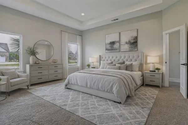 a bedroom with a bed a couch and dresser