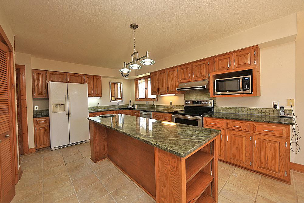 11716 Appaloosa Run East Raleigh, NC 27613 - Photo 7 of 30 Large kitchen with island, granite countertops and glass tile backsplash. Kitchen