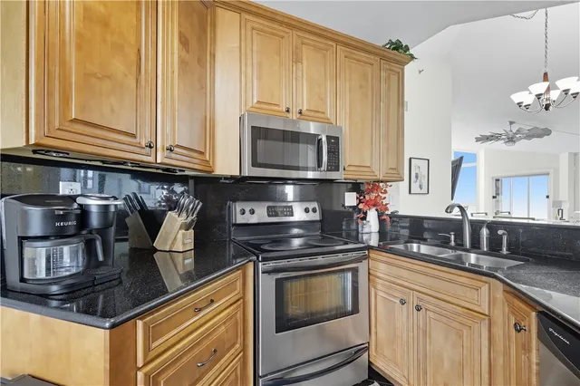 a kitchen with stainless steel appliances granite countertop a stove and a microwave