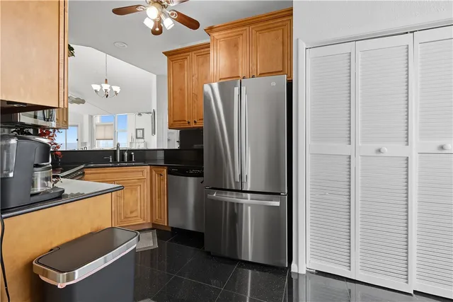 a kitchen with stainless steel appliances a refrigerator sink and microwave