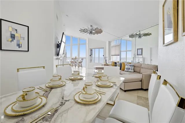 a dining room with furniture kitchen view and a chandelier