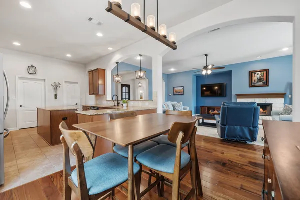 a dining room with kitchen island a table and chairs
