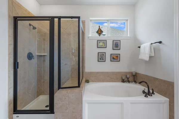 a bathroom with a bathtub and a shower