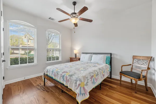 a bedroom with a bed a window and a dresser