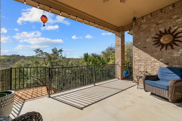 a view of balcony with wooden floor and iron fence