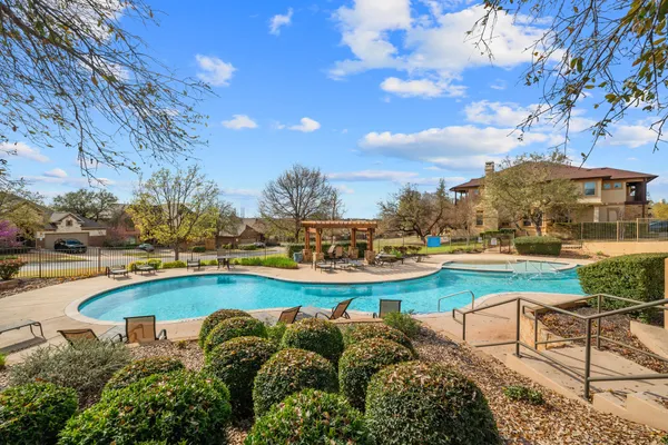 a view of a swimming pool and lounge chairs