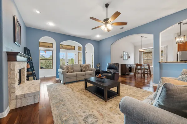 a living room with furniture a fireplace and a flat screen tv