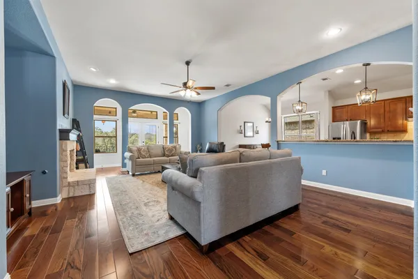 a living room with furniture and wooden floor