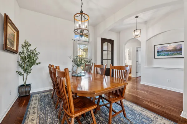 a view of a dining room with furniture wooden floor and chandelier