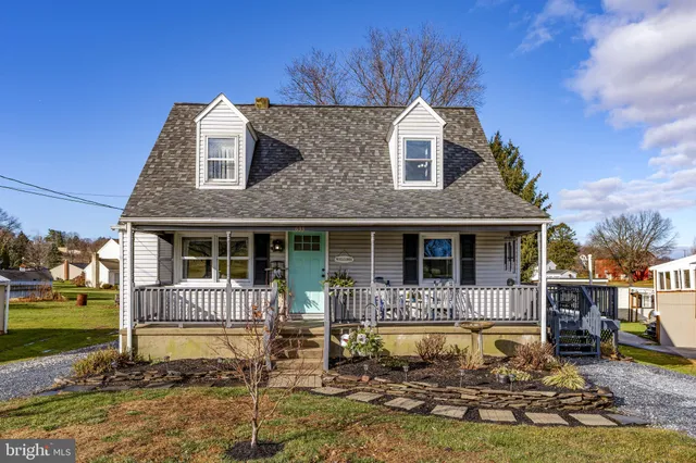 a front view of a house with swimming pool and porch