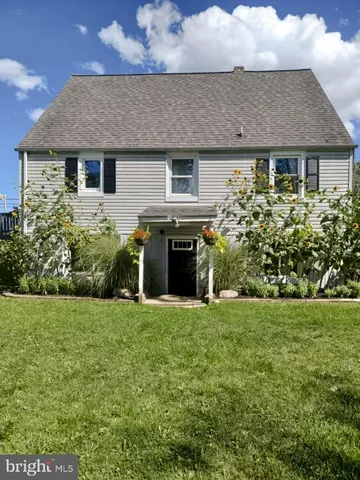 a front view of a house with a garden and plants