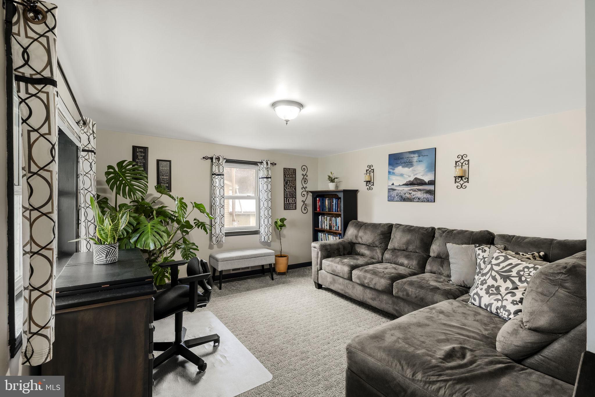 633 North Farmersville Road Ephrata, PA 17522 - Photo 26 of 54 a living room with furniture potted plant and a window