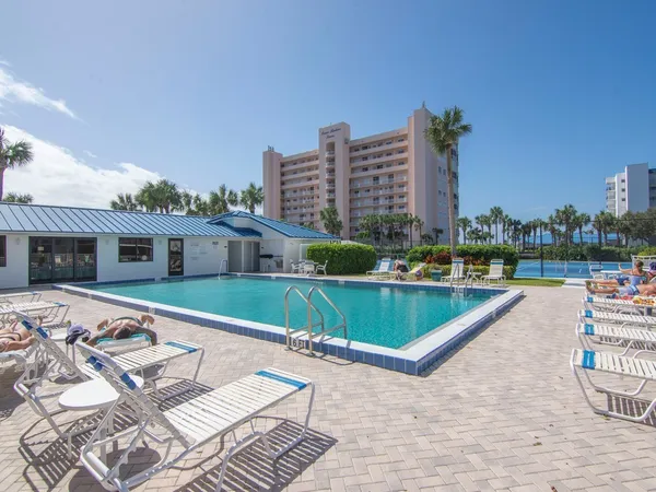 a living room with furniture a lamp and a table