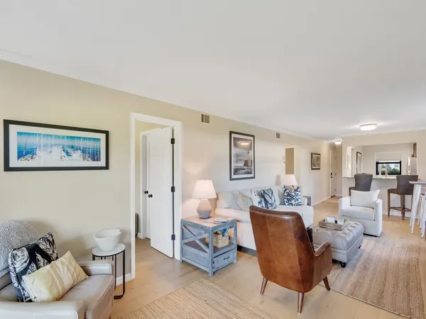 a view of a livingroom with workspace and a window
