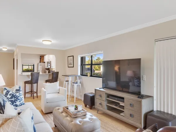a kitchen with stainless steel appliances a dining table and chairs