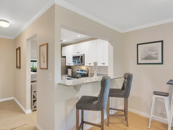 a kitchen with stainless steel appliances a stove microwave and refrigerator