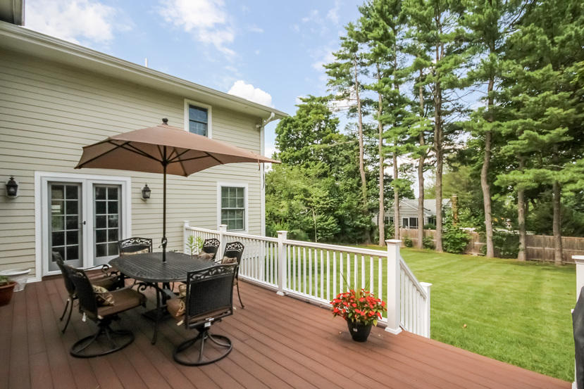 9 Field Crest Road New Canaan, CT 06840 - Photo 19 of 25 a view of a deck with table and chairs and floor to ceiling window