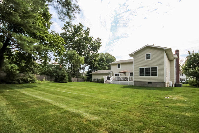 9 Field Crest Road New Canaan, CT 06840 - Photo 21 of 25 a big house with a big yard and large trees
