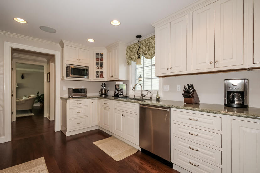 9 Field Crest Road New Canaan, CT 06840 - Photo 6 of 25 a kitchen with granite countertop white cabinets and stainless steel appliances